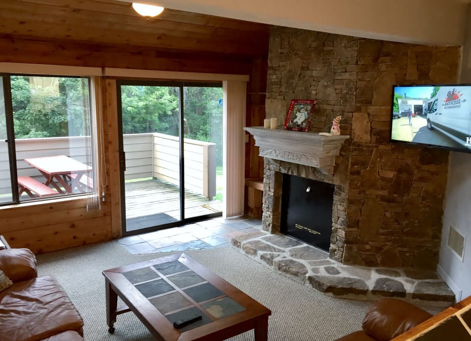 Living room looks out onto the private deck located on the Village Trail slope. 