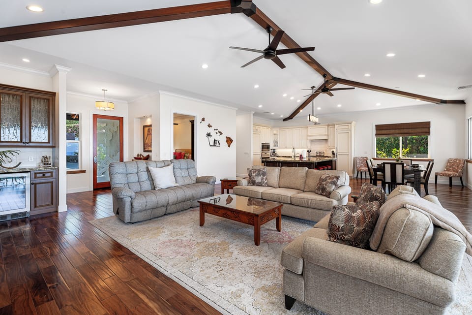 Vaulted ceilings and plush seating for comfort in the great room with a flat screen TV.