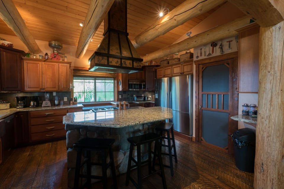 Two refrigerators, pantry and copper hood.
