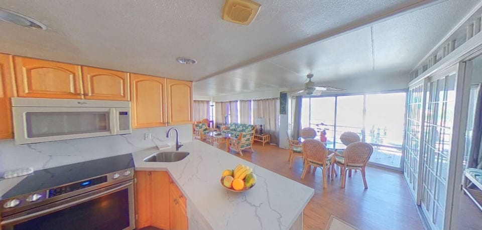 dining area and portion of living room, all with ocean views