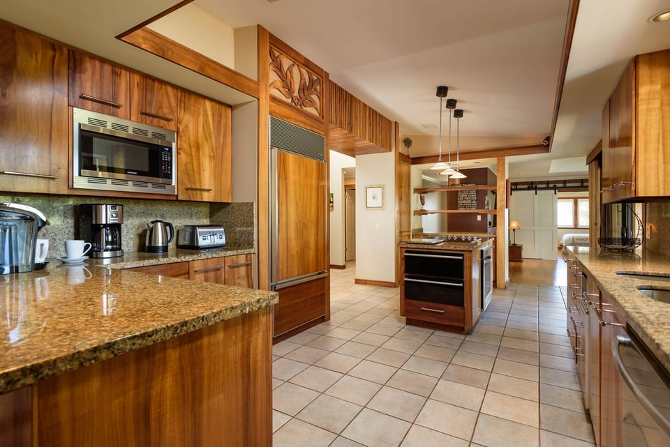Cook in style in this modern gourmet kitchen, featuring granite countertops, stainless steel appliances, and a spacious layout for culinary enthusiasts.