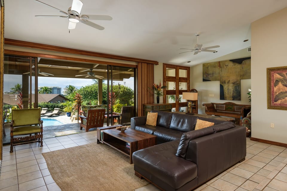 This open-concept living area offers modern design, comfort, and direct views of the pool and garden. A perfect hub for family and friends.