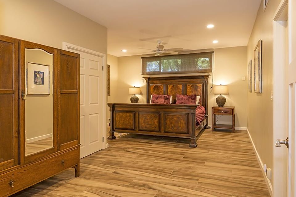 This suite boasts modern amenities, a grand bed, and vintage-style wardrobe, offering comfort and style for your Hawaiian getaway.