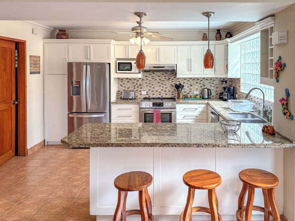 Family-ready kitchen with spacious island, cozy seating, all the essentials.