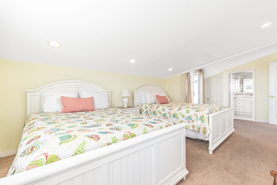 2nd bedroom on the third level includes two queen beds and sliding doors that lead to a rear private deck.
                