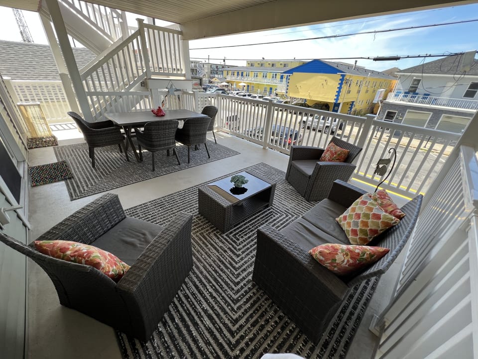 Covered porch with dining table for 6+ people and comfortable lounge area