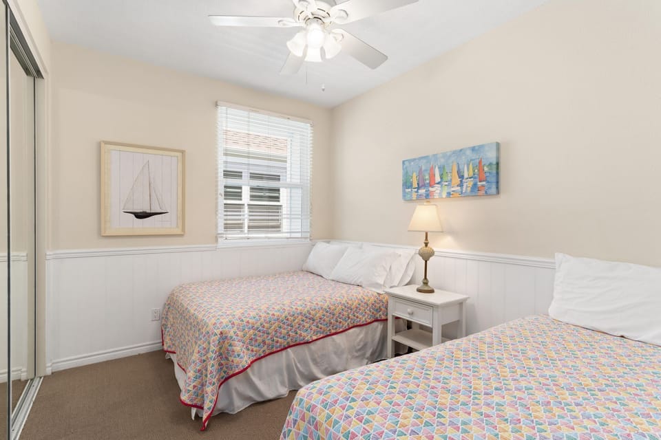 Bedroom #2 is outfitted with one Full and one Twin bed; linens, ceiling fan, closet, and carpeting. Located along central hallway.
                
