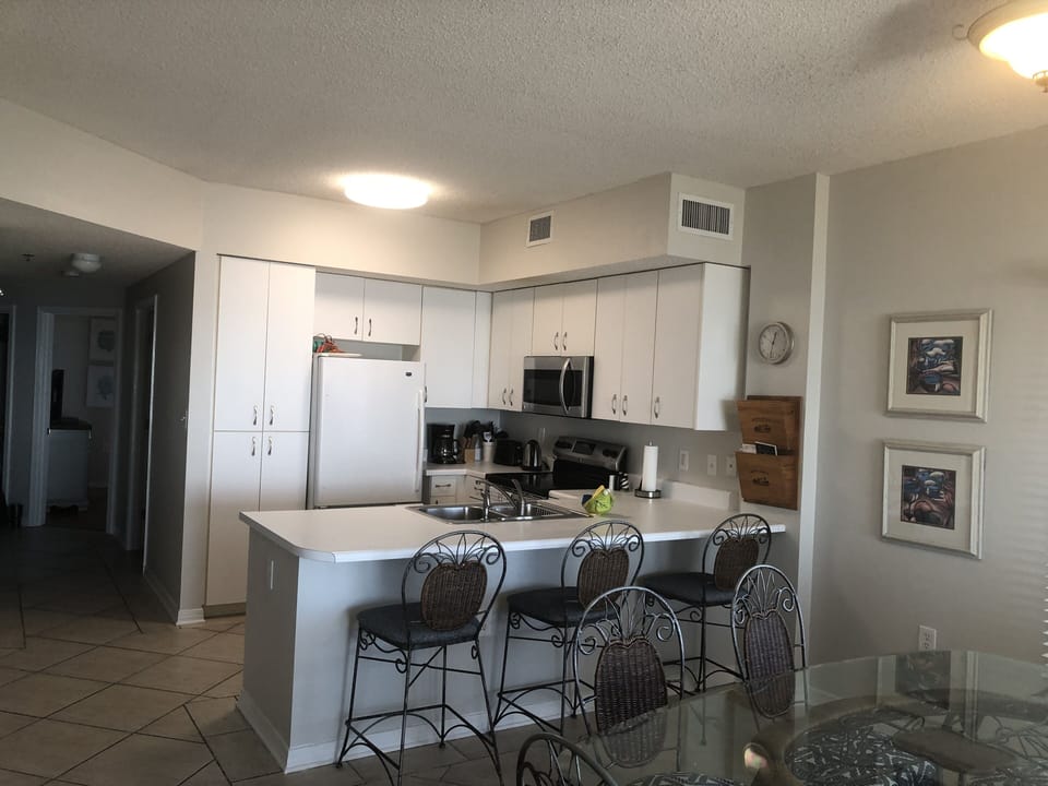Kitchen with breakfast bar that seats three.