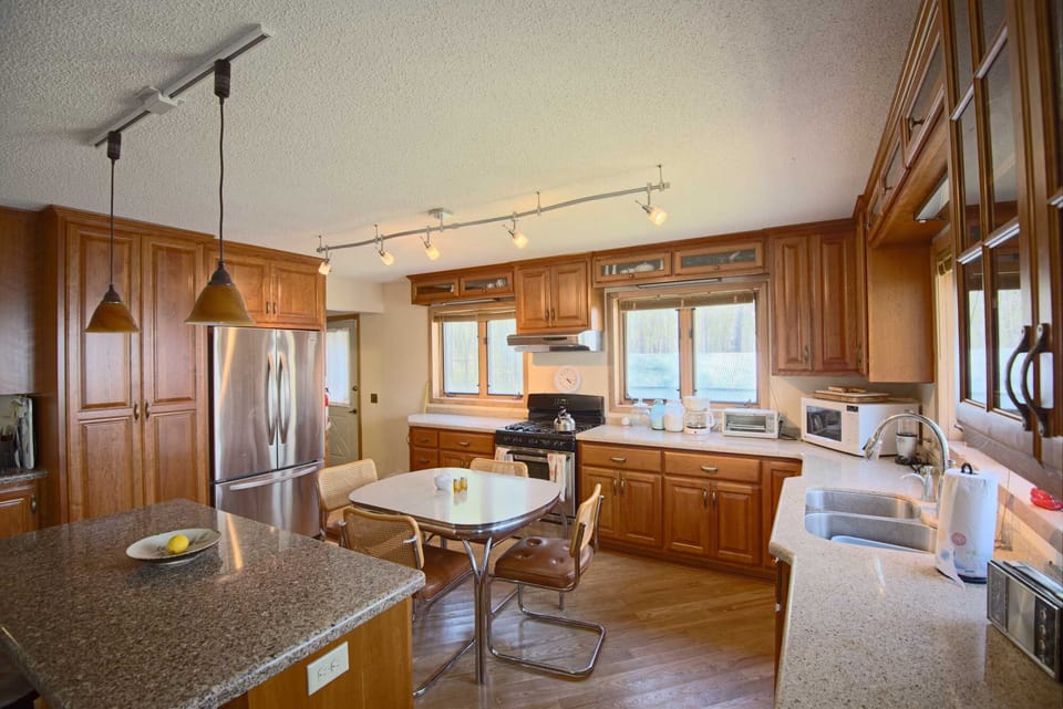 Large kitchen, gas stove, dishwasher and (enclosed) washer/dryer next to frig. 