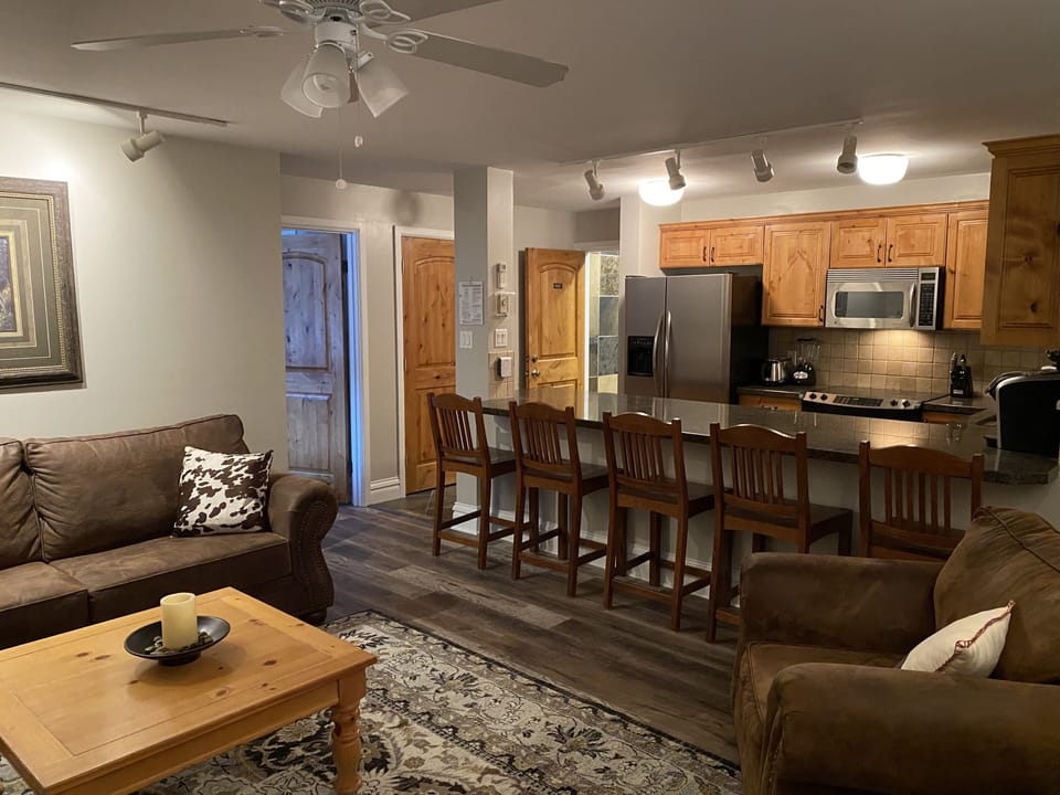 Large granite eating counter with 6 chairs (6th chair is at the desk in corner.)