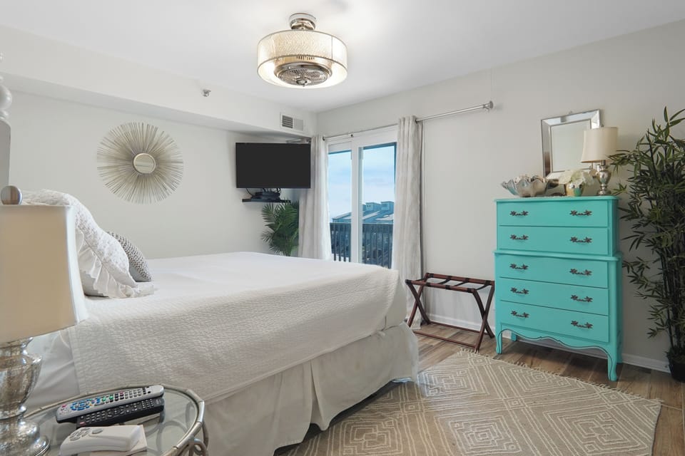 Primary Bedroom Ocean view full bath porcelain wood plank floor King size bed  