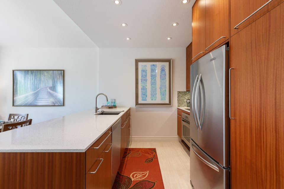 Open galley kitchen is fully stocked with everything you need to prepare meals 