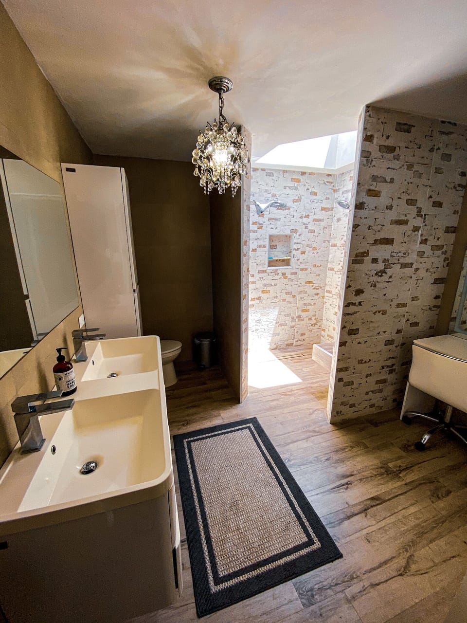 Master bathroom with additional seating/vanity mirror to the right