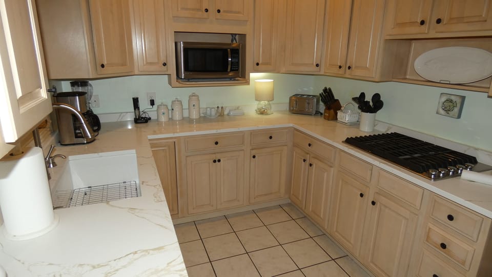Quartz countertops, large sink, and microwave.