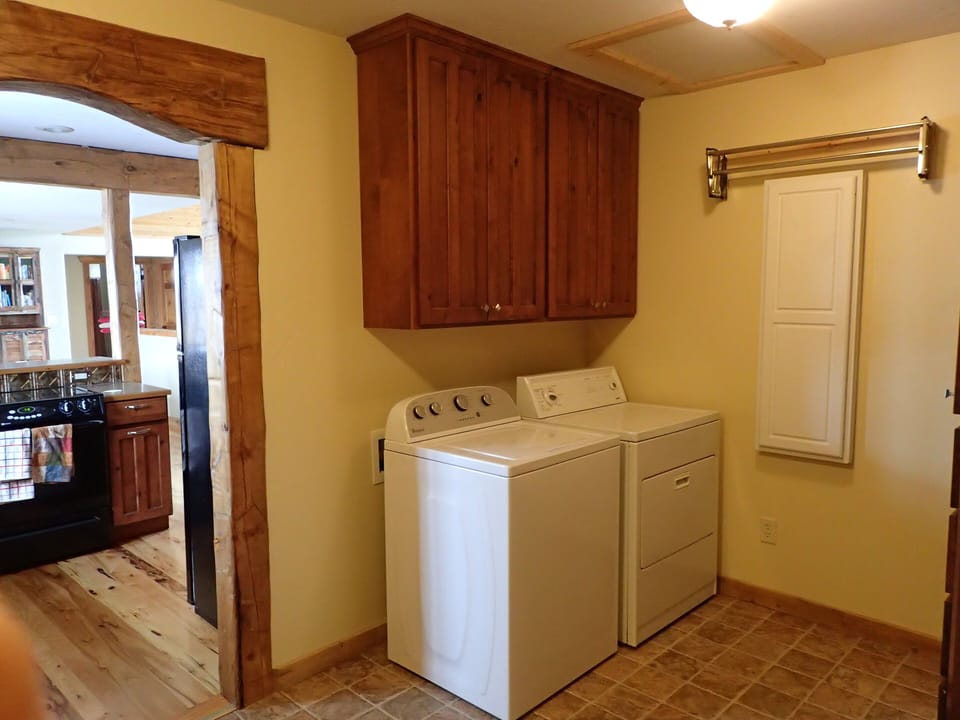 Mudroom looking towards the kitchen. Washer, Drier. Lots of racks and shelves 