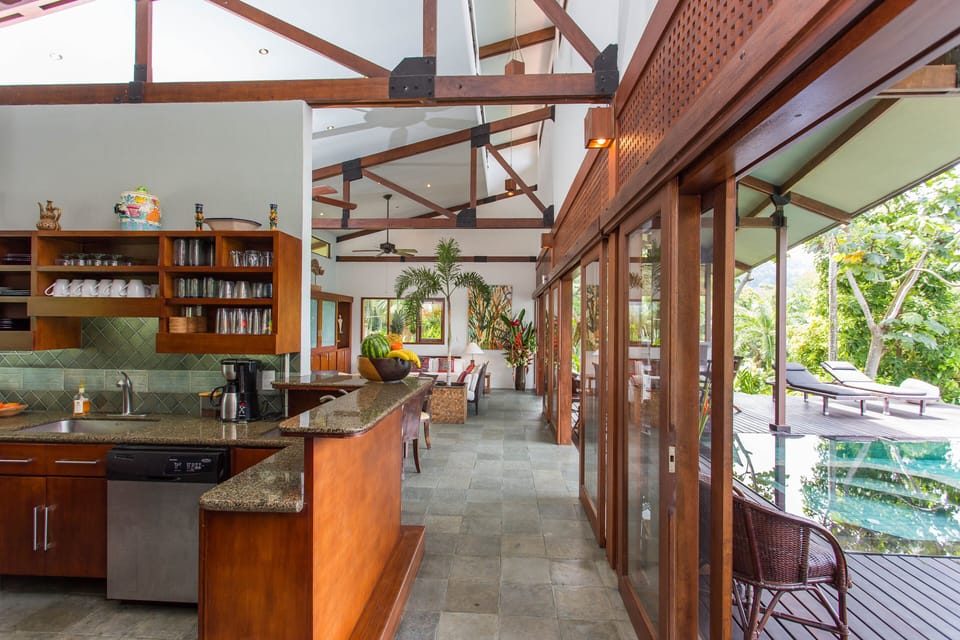 To the left, the living areas and pool deck separated by a wall of sliding doors