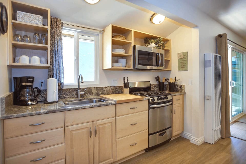 The kitchen comes stocked with dishes, utensils, bakeware, cookware, and large and small appliances (but no dishwasher).
                