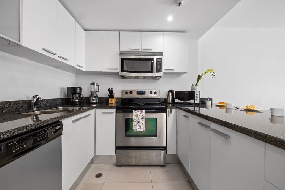 Cook your favorite meals with sleek appliances and ample counter space in this bright, modern kitchen—perfect for whipping up breakfast or preparing a home-cooked dinner.