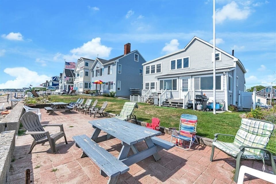 Shared back porch with each unit equipped with its own picnic table.