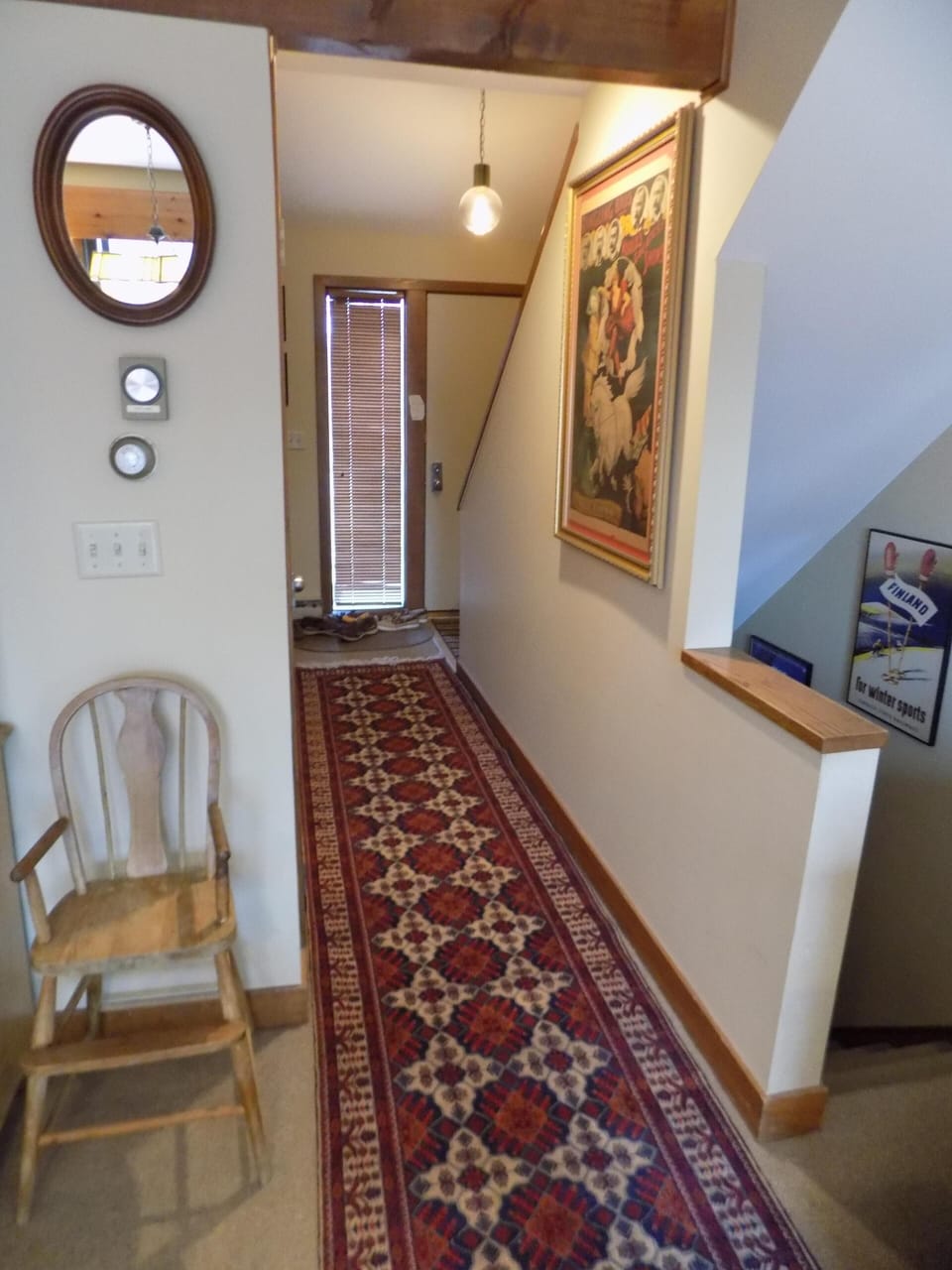 Main entry hall looking from dining room to front entry