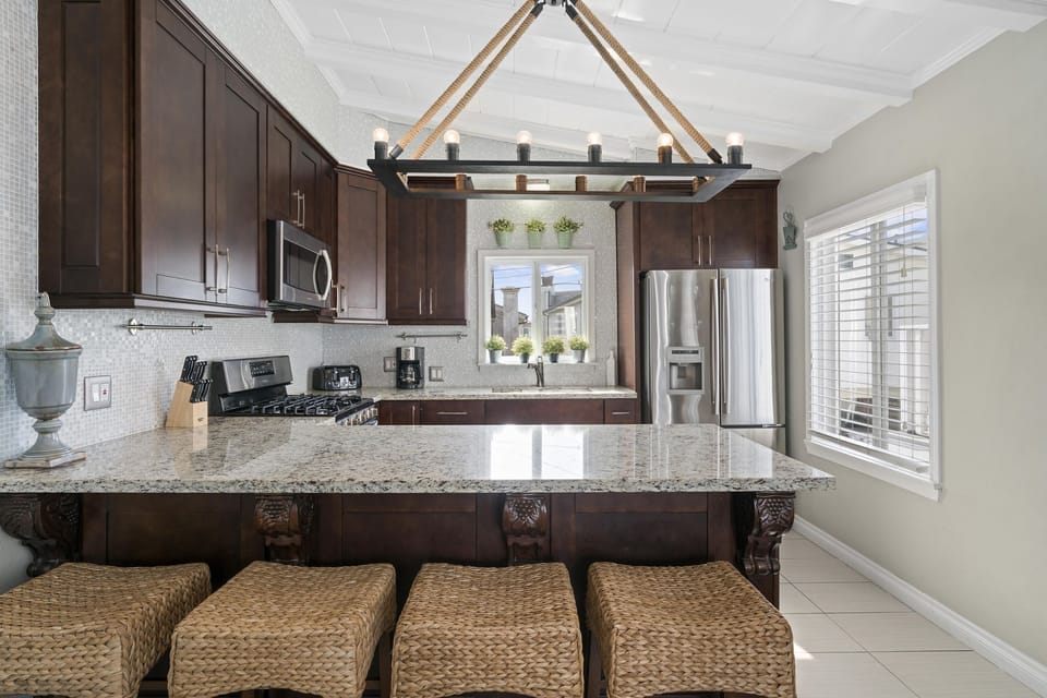 Kitchen is stocked with dishes, cooking, baking and meal prep gear. All standard large and small appliances included (but no dishwasher) and barstool seating.
                