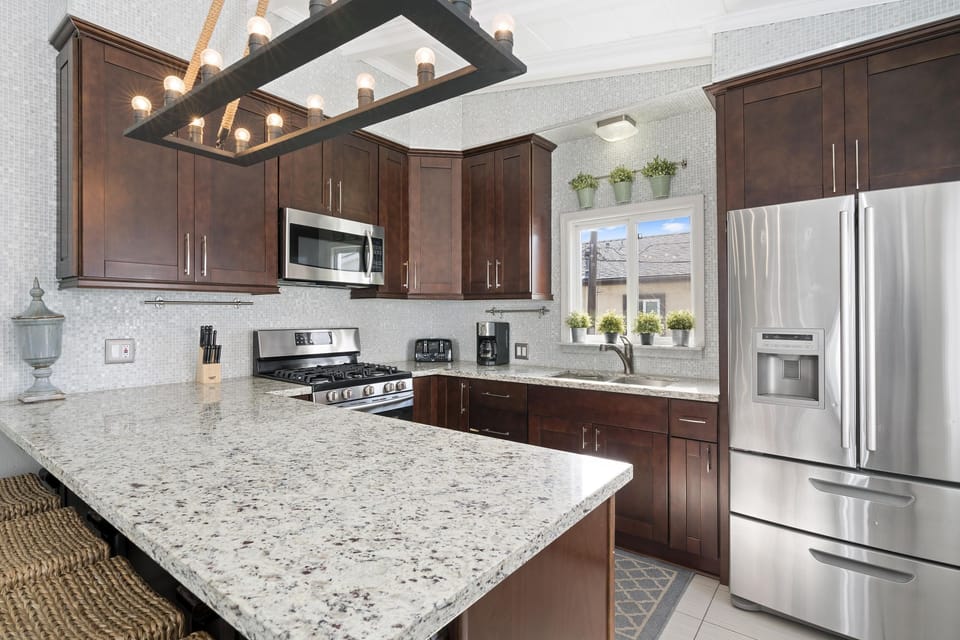 Kitchen is stocked with dishes, cooking, baking and meal prep gear. All standard large and small appliances included (but no dishwasher) and barstool seating.
                