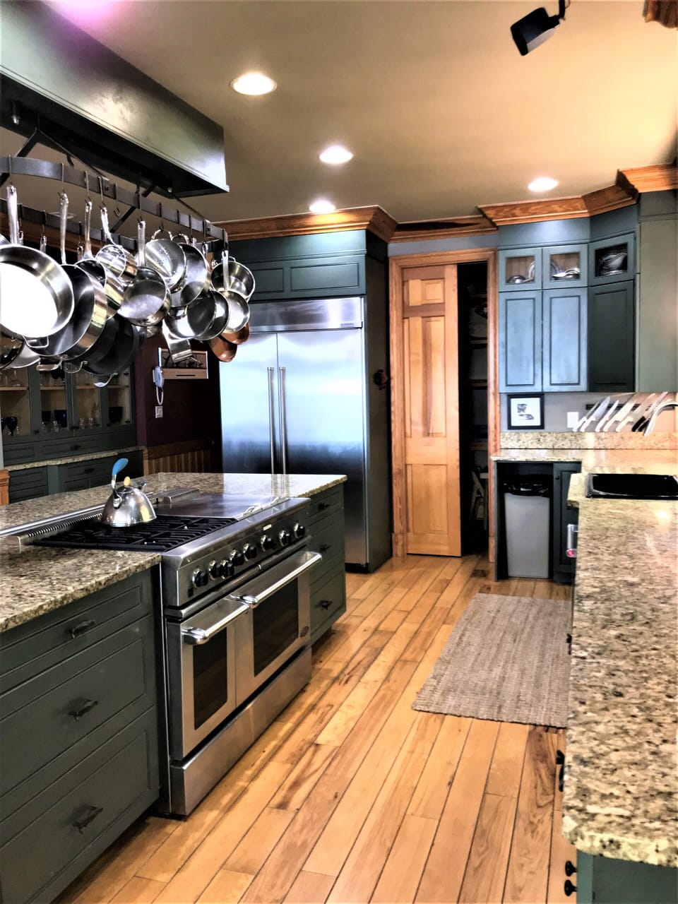 large main kitchen work area with 48" refrig and walkin pantry with the 2nd sink