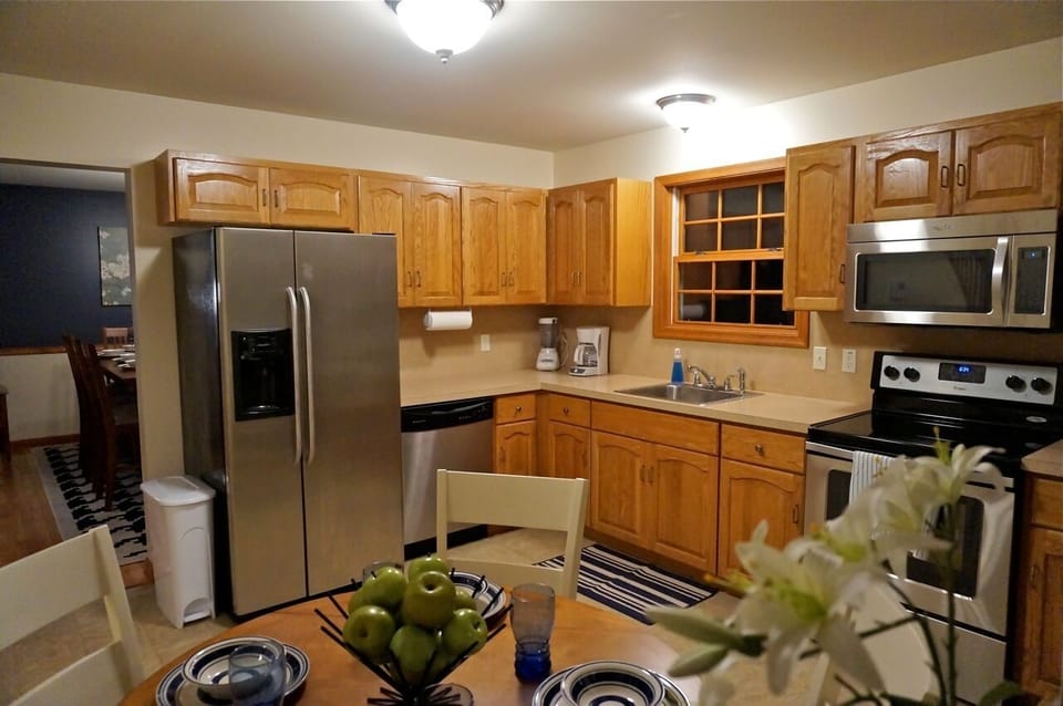 Fully stocked modern kitchen with stainless steel appliances