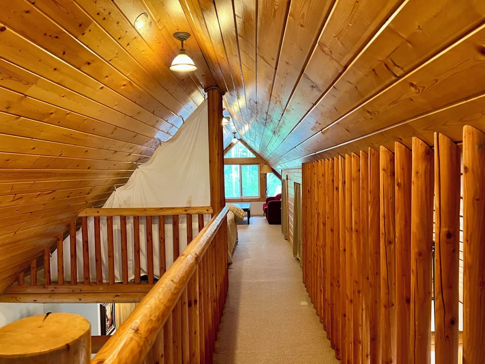 Walkway at top of stairs to entry side loft bedroom 