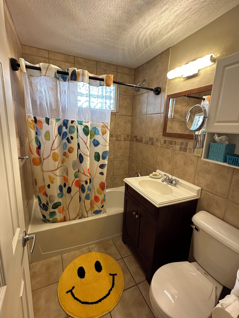 The 2nd floor bathroom has a tub, shower, magnifying mirror and toiletries.