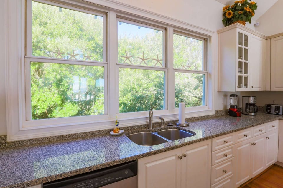 The kitchen windows overlook the tree tops in the back yard.