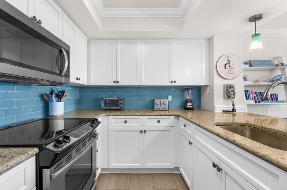 Cook meals with ease in the fully equipped kitchen featuring sleek stainless steel appliances and plenty of space for preparing your favorite vacation dishes.