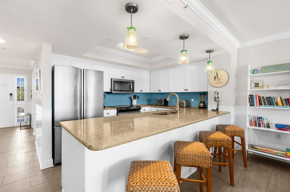 The island offers comfortable seating for four, providing the perfect spot for morning coffee, casual meals, or keeping the cook company.