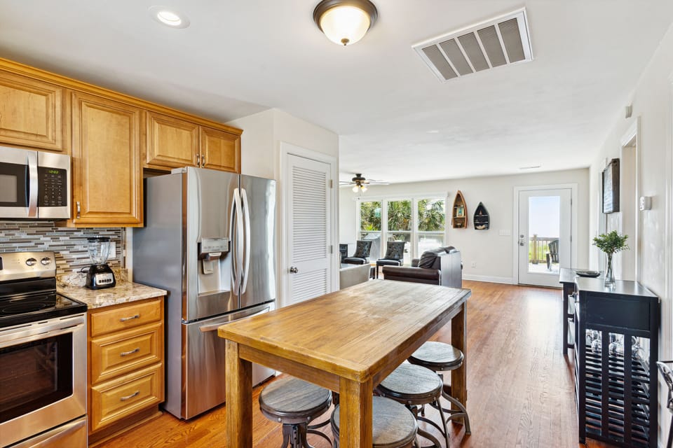 The kitchen island doubles as a seating area for meals, with seating for 6.