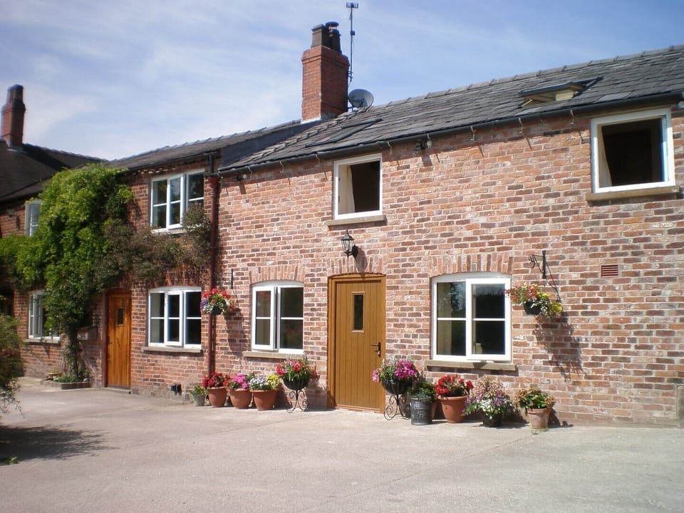 Farmhouse Cottage on the left adjoins our Swallows Barn Cottage on the right