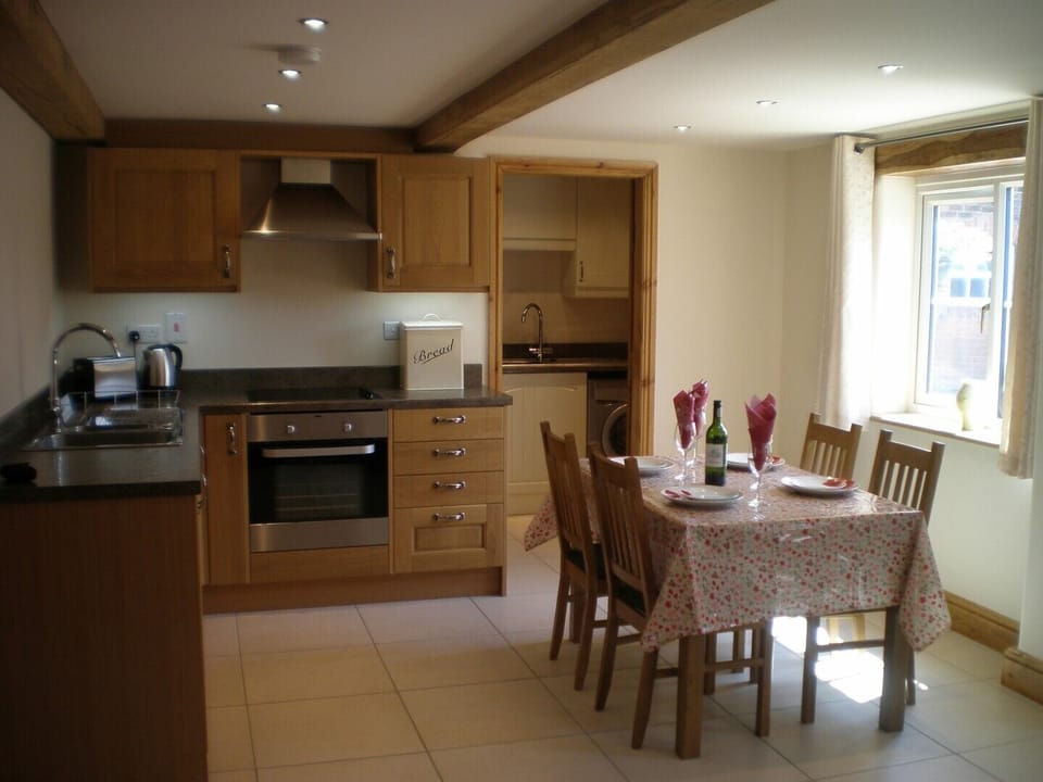 Kitchen area showing the oak beams and adjoining utility / wc room 