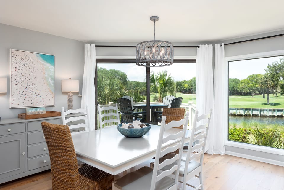 The dining room has floor to ceiling windows with amazing views of the lagoon and 18th fairway of Crooked Oaks