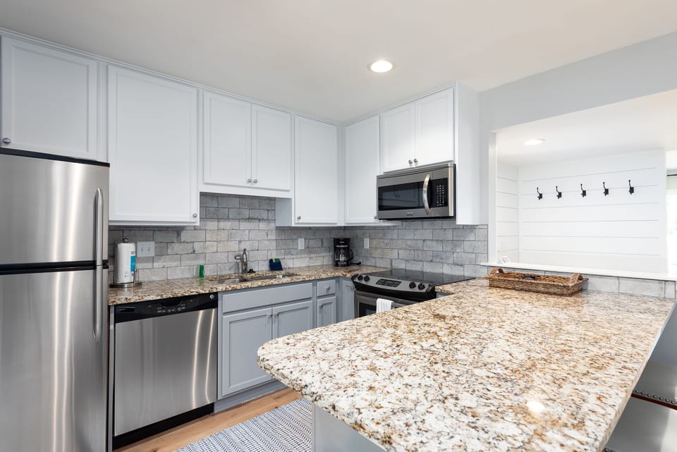 The kitchen sits off the entry. Stainless steel appliances and granite counter tops.