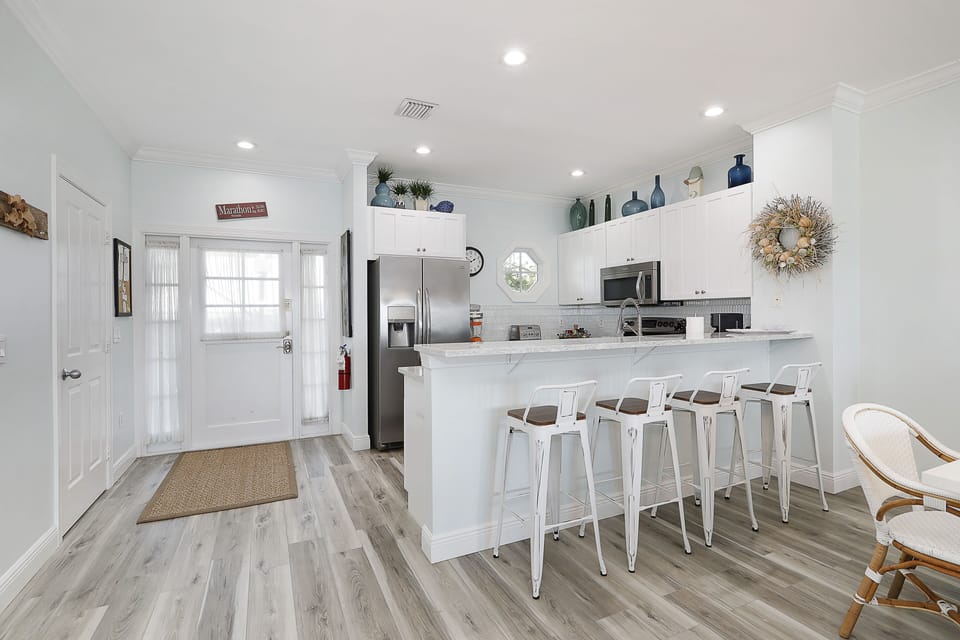 Plenty of seating between large dining table and bar stools