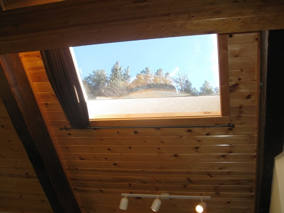 Skylight with mountain view features retractable cover