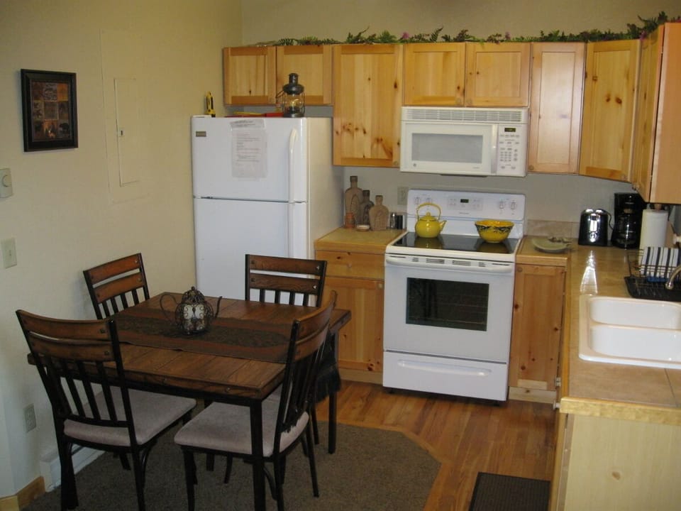 Another view of the kitchen and dining table