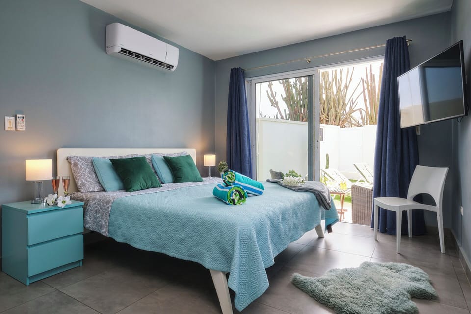 Our master bedroom has a KING bed, airconditioning and a TV 