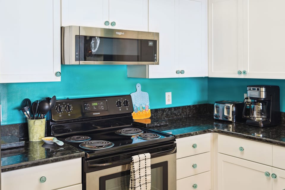 Fully equipped kitchen, overlooks the dining room and living room.