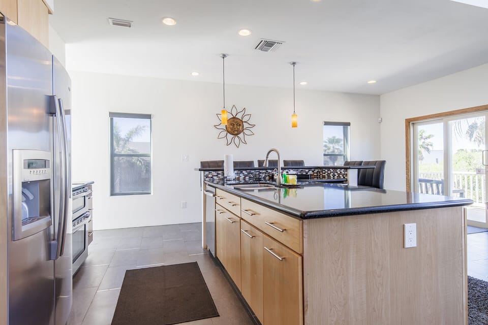 Open kitchen with island and bar seating.