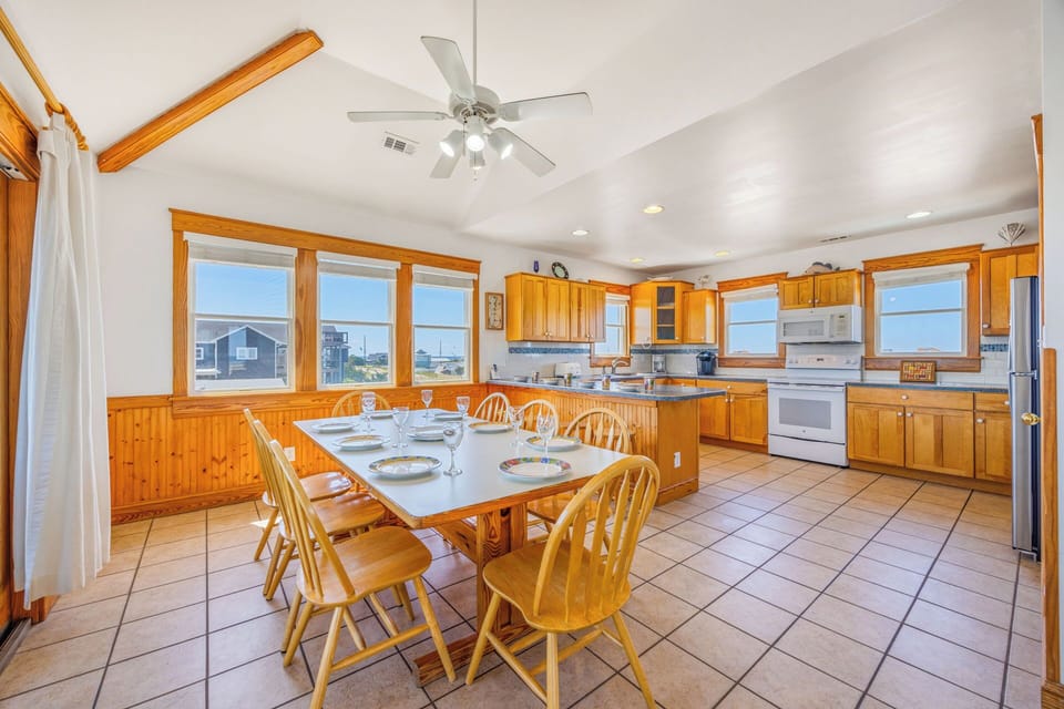 Sunlight fills this spacious kitchen where you'll gather for home-cooked meals around the welcoming table, with warm wood tones and all the appliances you need to create memories together.