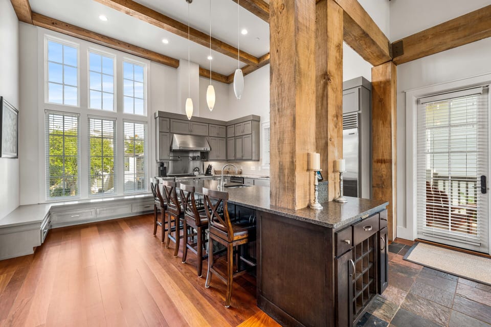 Gourmet kitchen with every feature you could possibly need, surrounded by window bench seating and a spacious dining area
