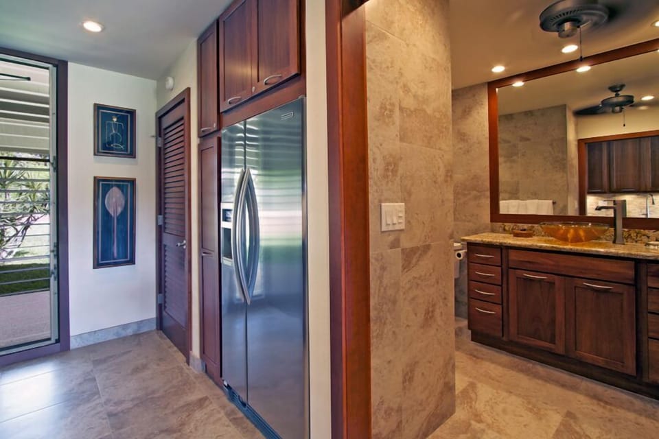Fridge with filtered water dispenser located next to front load washer/ dryer