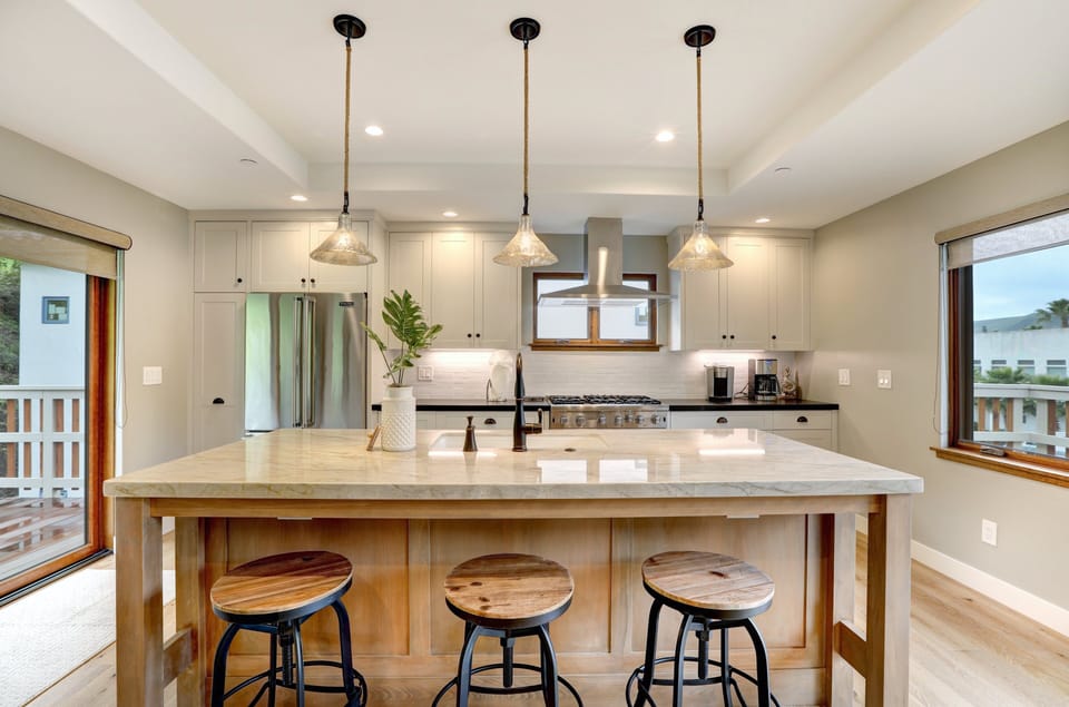 Chef kitchen with large center island for meal prep and friends to gather.