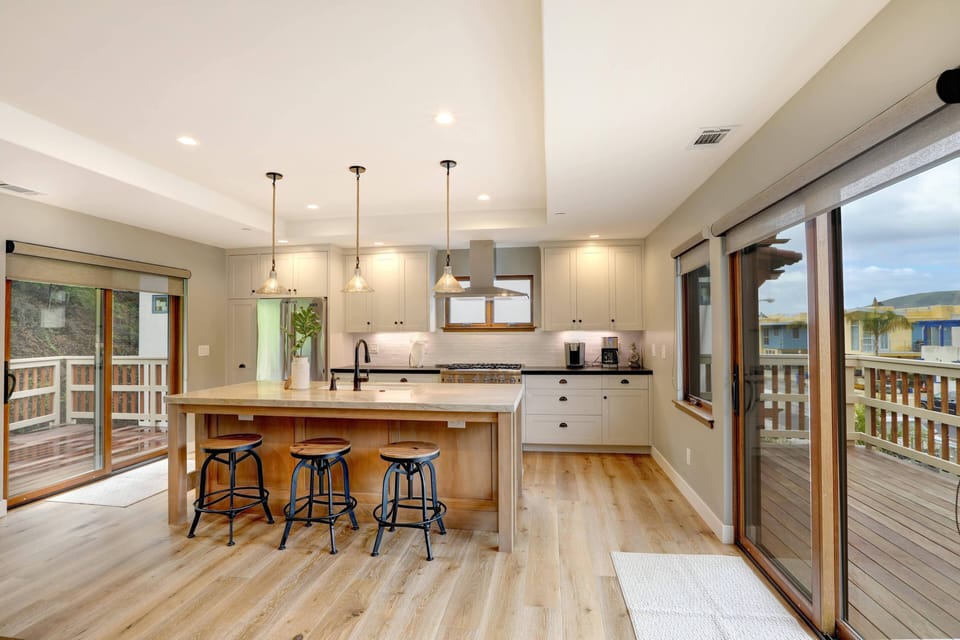 Open space living, dining and kitchen. Bar seating for 3 plus dining for 10