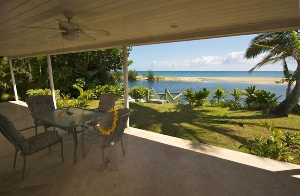 Covered lanai with gas BBQ and outdoor dining.